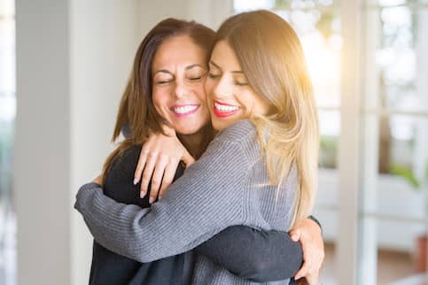 Mother and daughter hugging after discussing executor of estate duties. 