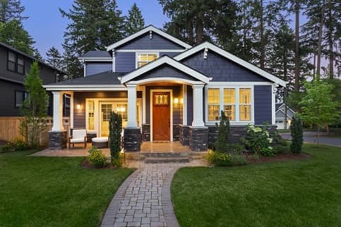 Indigo and white home with stone pathway