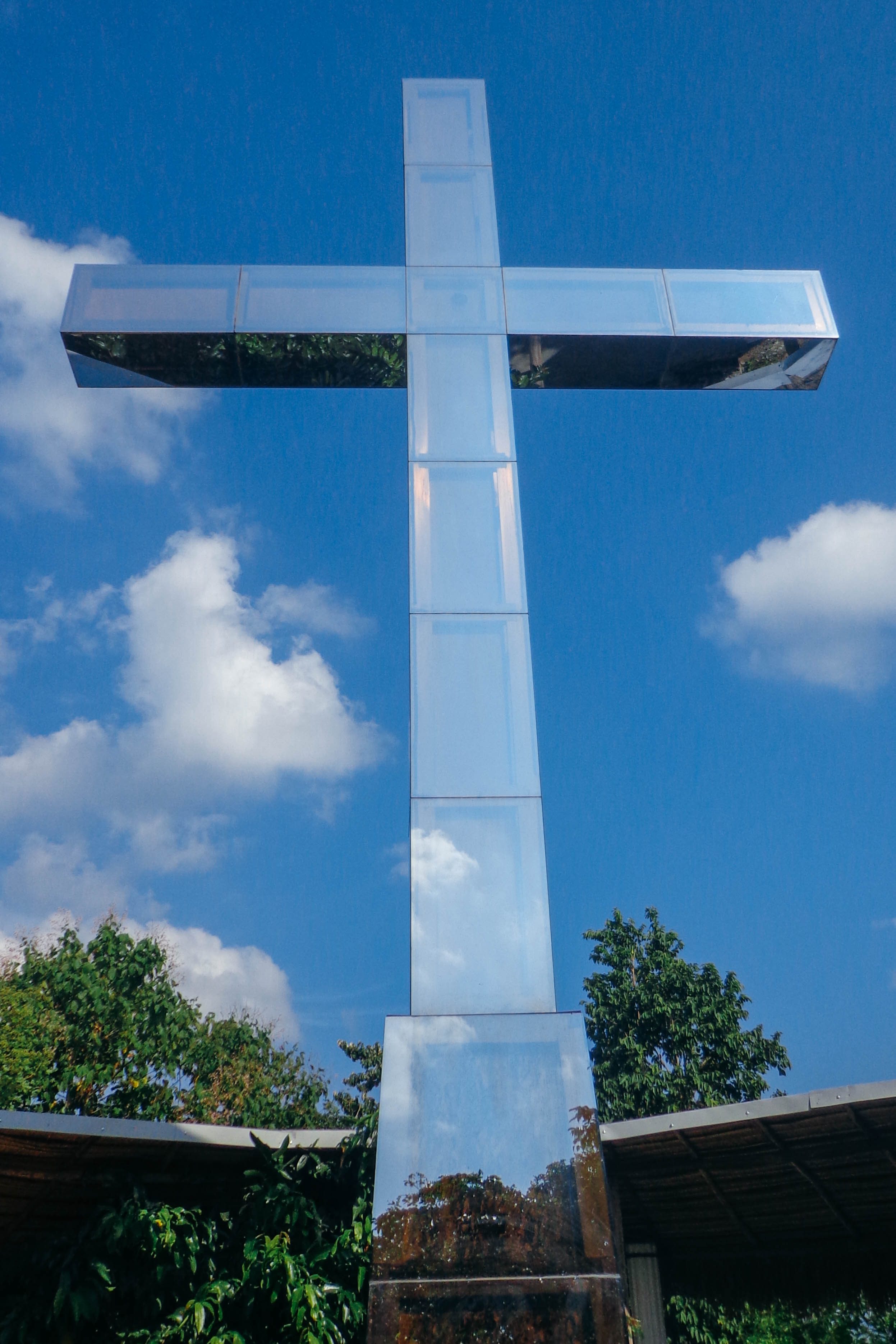 REFLECTION. The cross atop the mountain reflects the color of the sky and provides a respite after a tiring climb up. Photo by Joshua Berida 