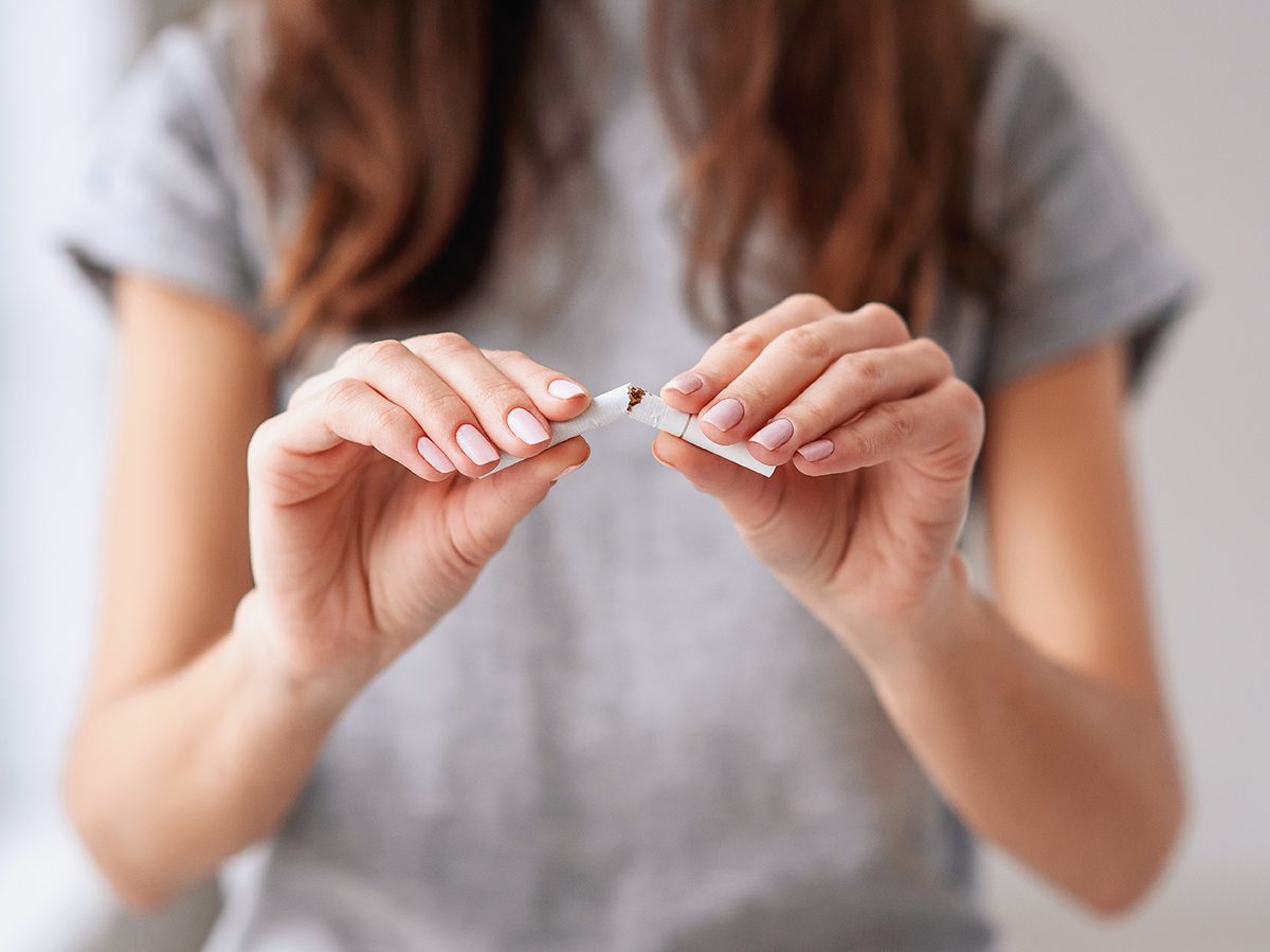 Woman breaking cigarette - stop smoking