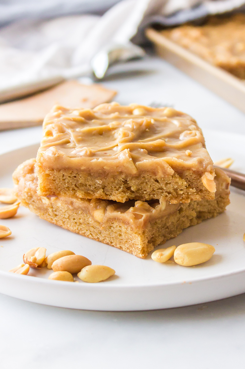 two slices peanut butter sheet cake stacked on plate