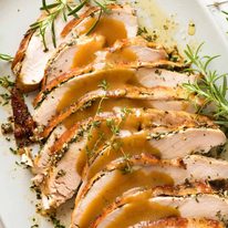 Slices of Slow Cooker Garlic Herb Turkey Breast on a plate, ready to be served