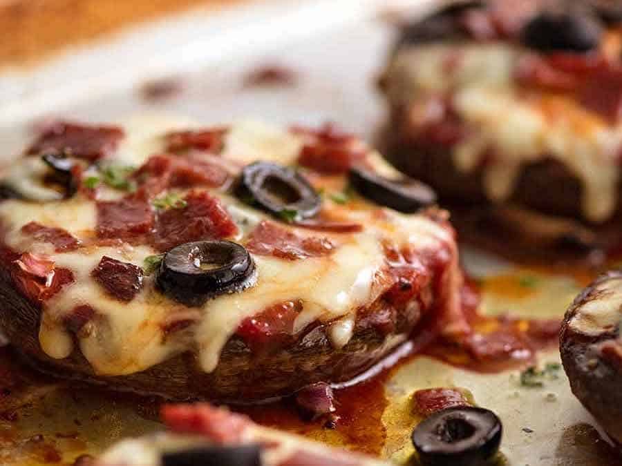 Close up of Pizza Stuffed Mushrooms with pepperoni, salami, olives and onion