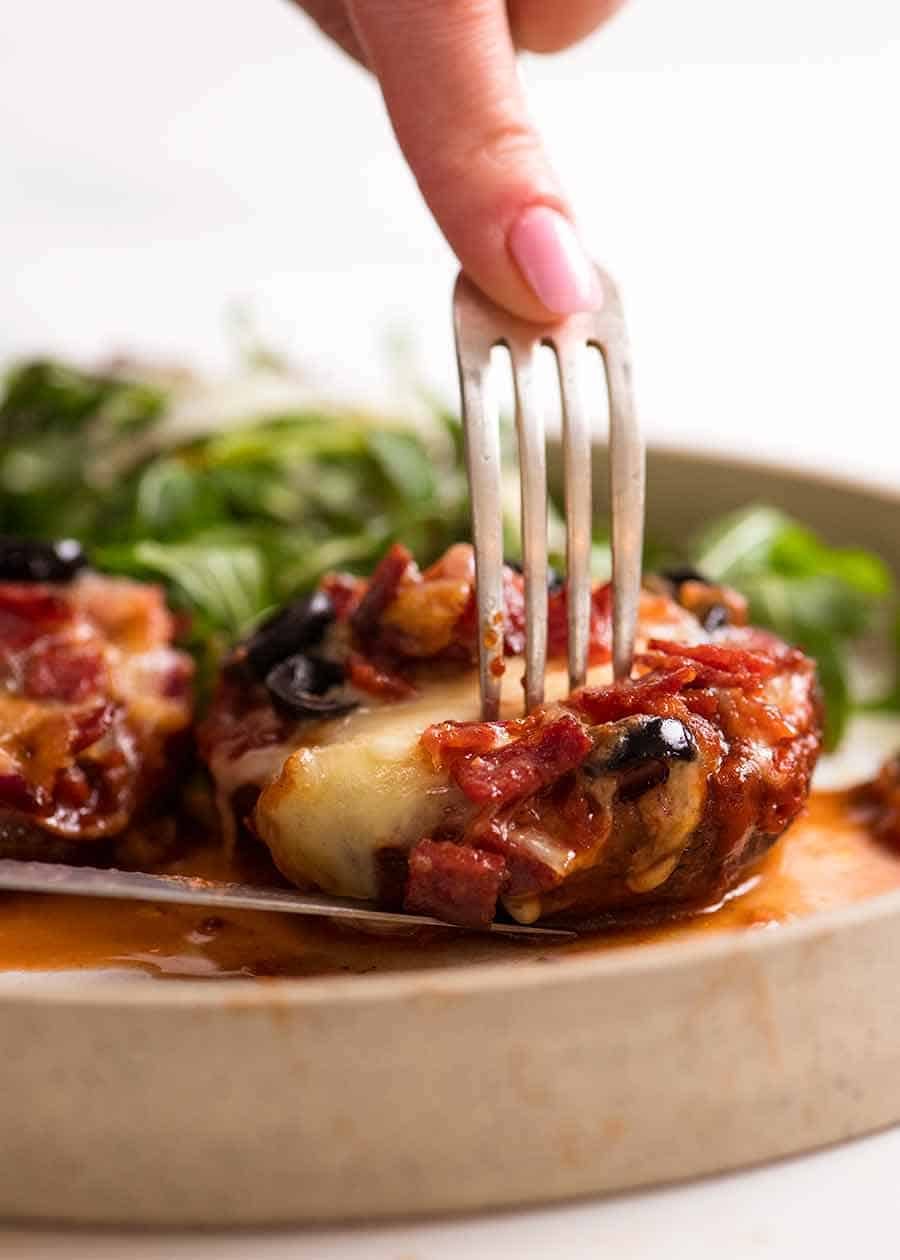 Pizza Stuffed Mushrooms on a plate with a side salad