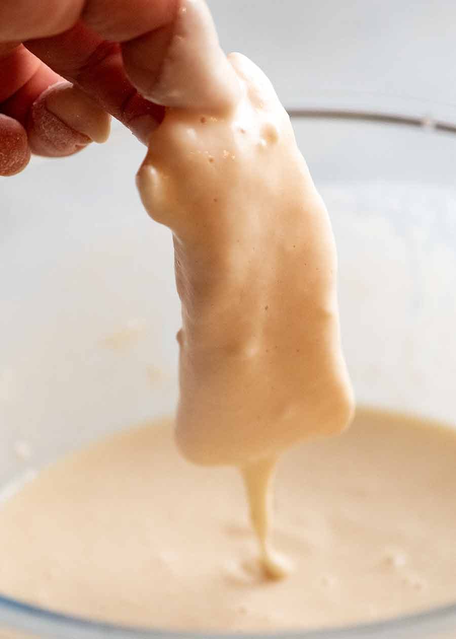 Dipping fish into beer batter