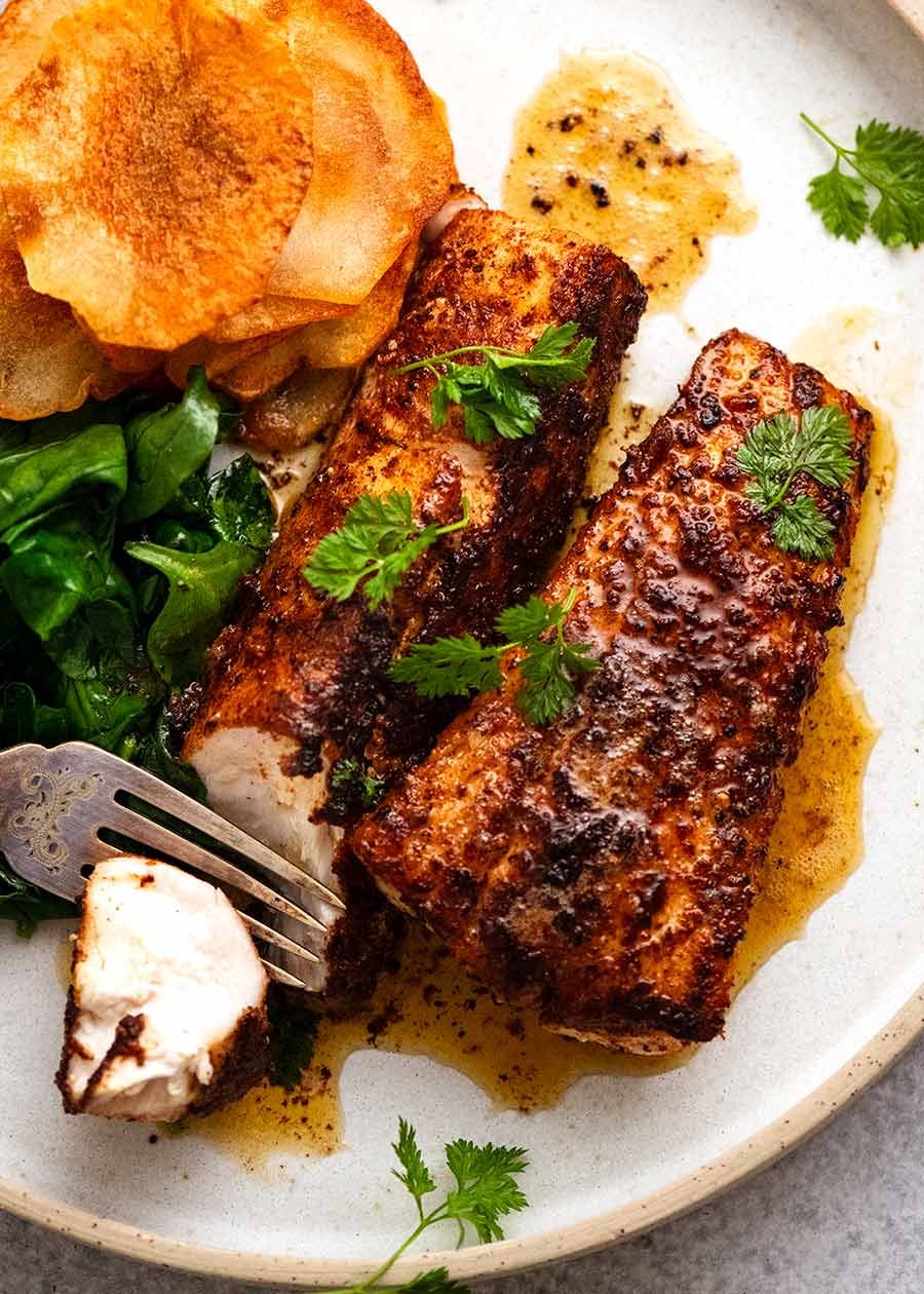 Flathead fillets cooked with seasoning on a plate, fresh off the stove