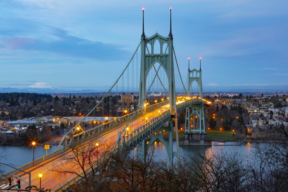 St Johns Bridge over the Willamette River in Portland, Oregon with Mt St Helens and Mt Adams in the background.