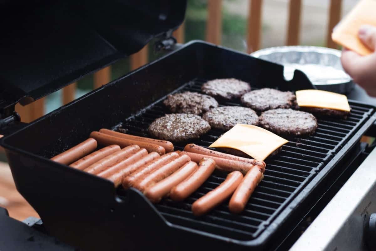 hot dogs and hamburgers on the grill