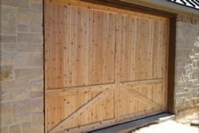 natural wood garage door with no hardware