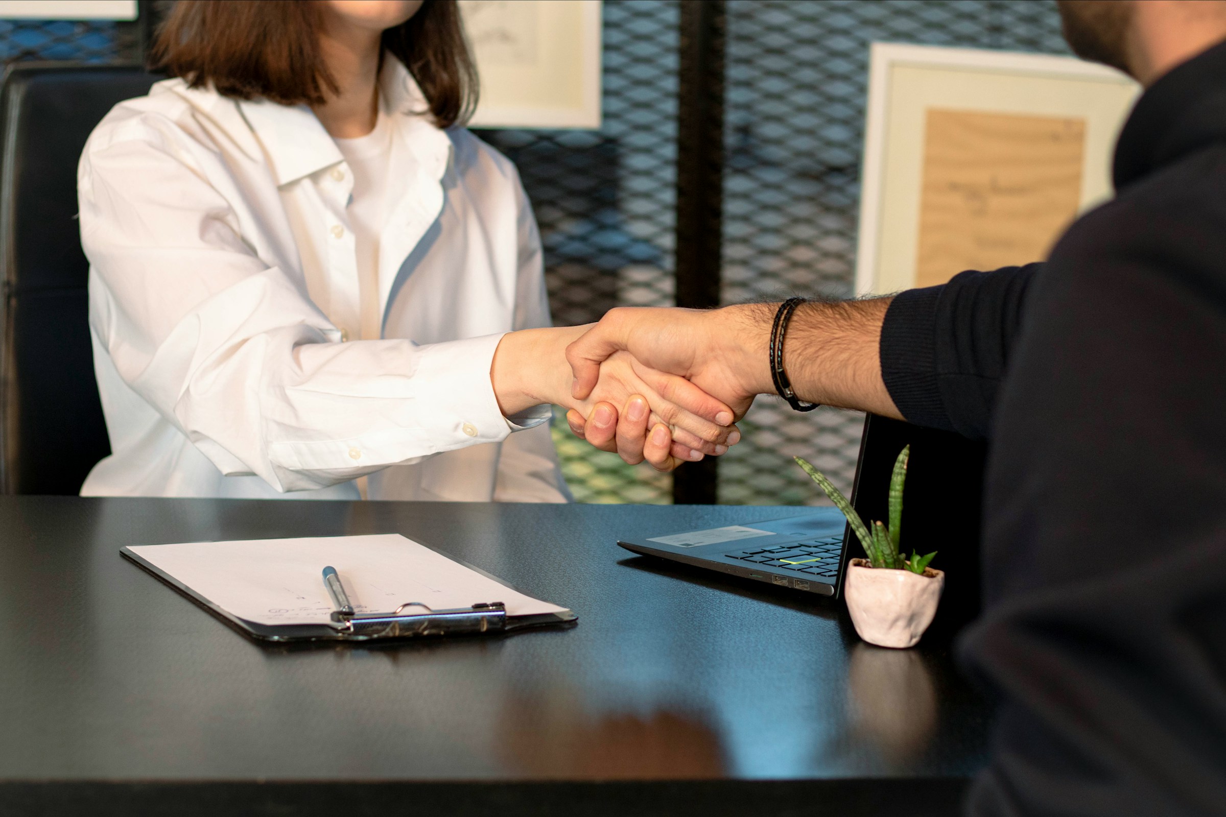 woman shaking hand - How Long Is a Resume Supposed to Be