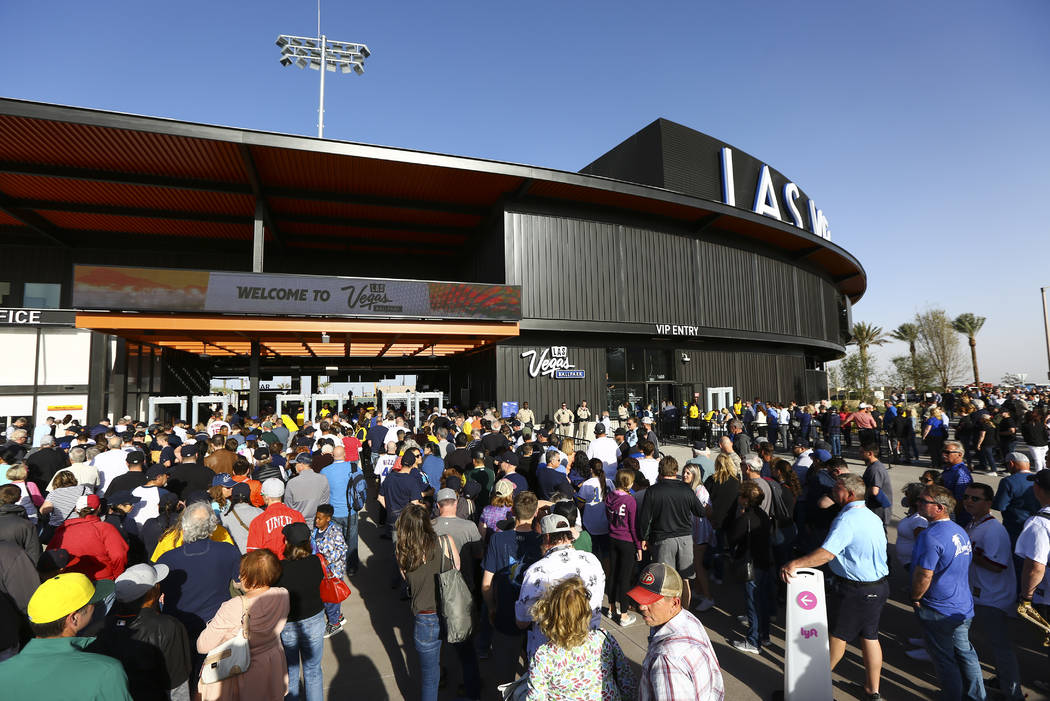 Fans line up to enter the Las Vegas Ballpark for the Las Vegas Aviators' home opener in Downtow ...