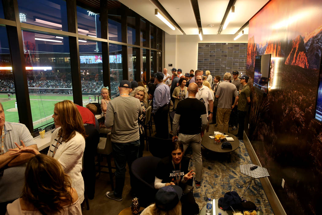 Fans watch from one of the party suites on the first-ever opening night for the Las Vegas Aviat ...