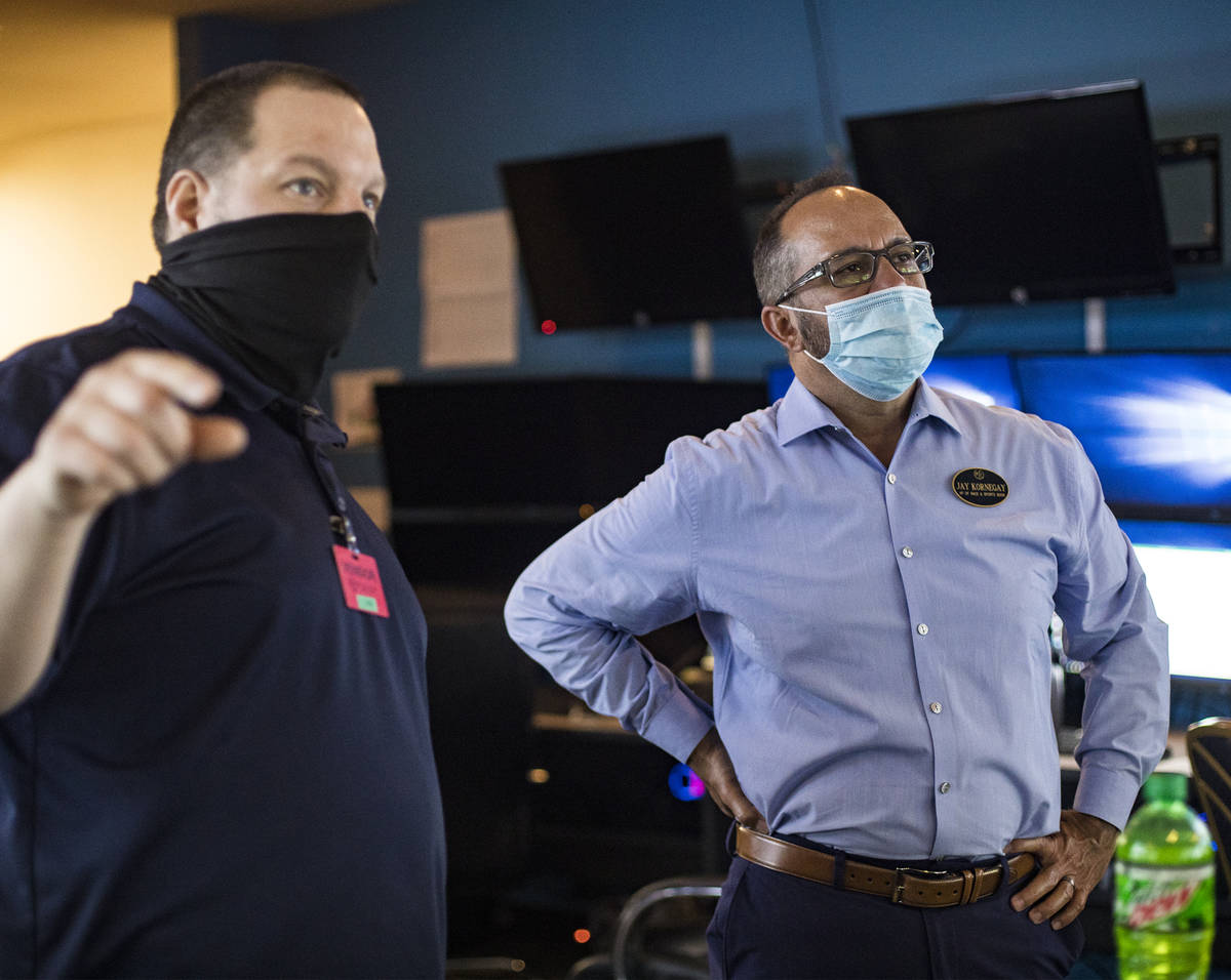 Jay Kornegay, vice president of Westgate Sportsbook, right, talks with Doug Whelan, a system in ...