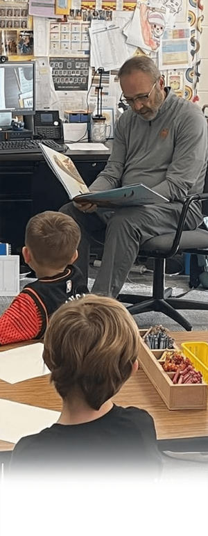 Dr. Matthews reading to young students.