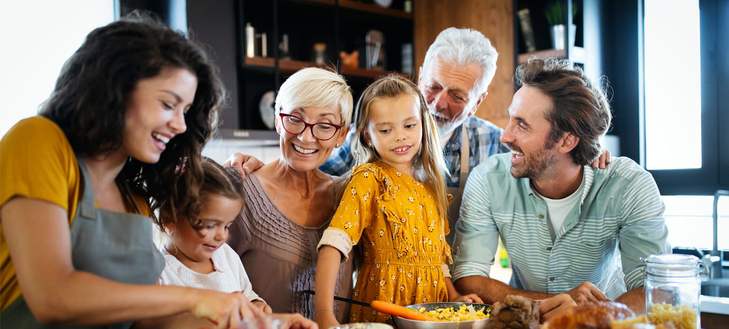 3 generations of family around a kitchen worktop