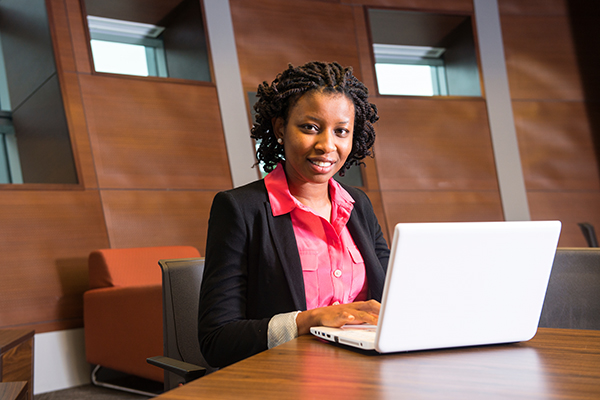 A woman typing on a laptop