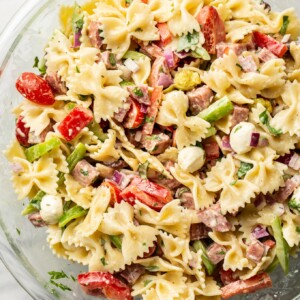 a glass bowl with italian pasta salad