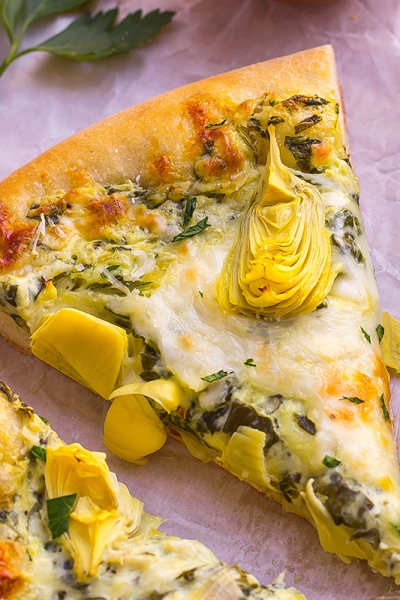 one slice of spinach artichoke pizza