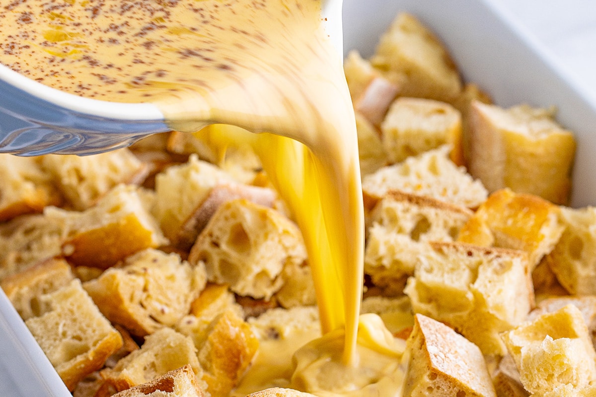 egg mixture poured into bread cubes