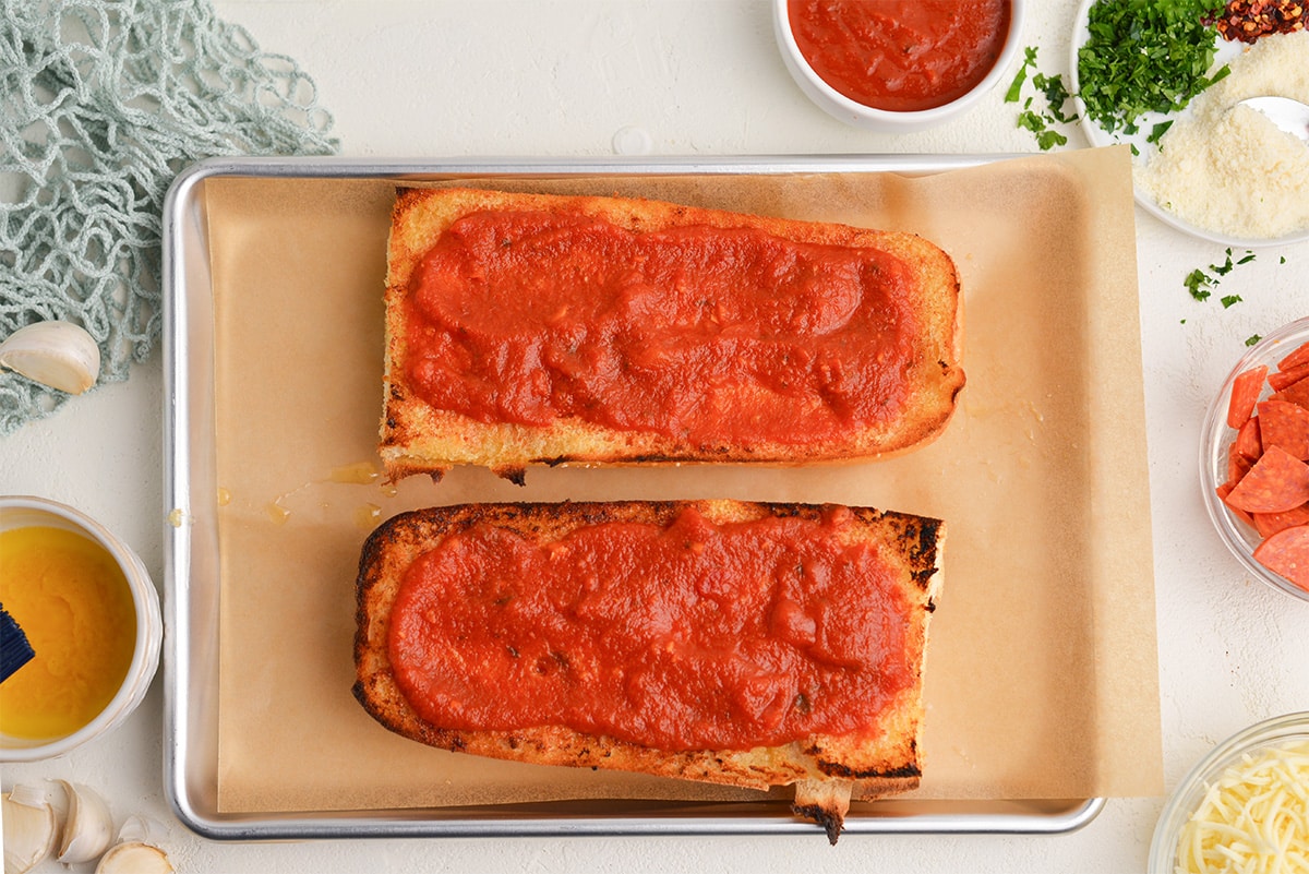 marinara sauce spread onto toasted bread