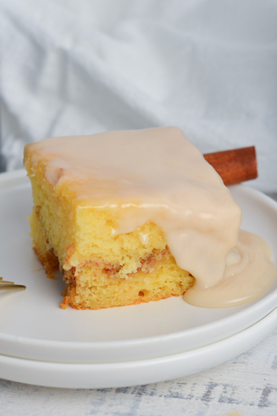 angled shot of slice of honey bun cake on plate