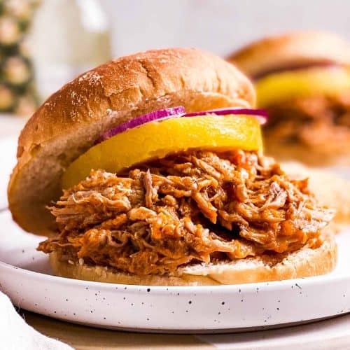 pineapple pulled pork on sandwich bun with canned pineapple ring