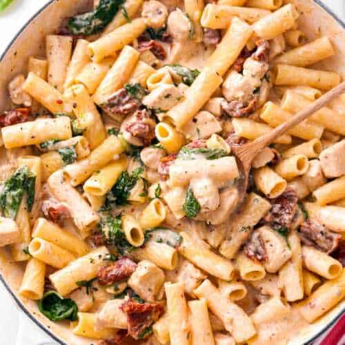 overhead view of cast iron pan filled with tuscan chicken pasta