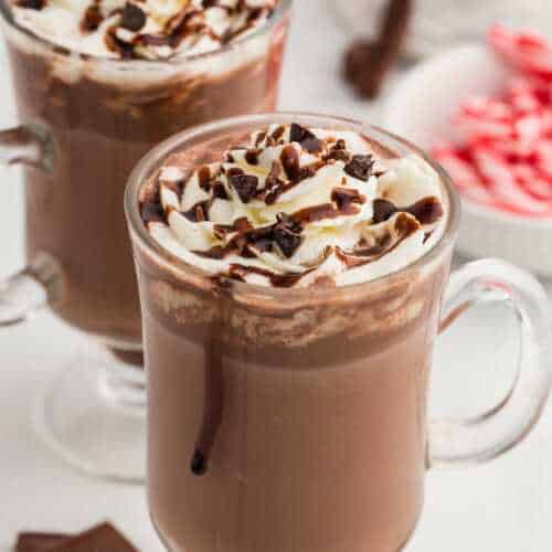 frontal view of two glass mugs of hot chocolate