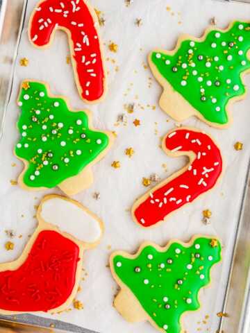 overhead view of christmas decorated sugar cookies on baking tray