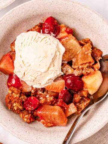 overhead view of cranberry apple crisp with ice cream