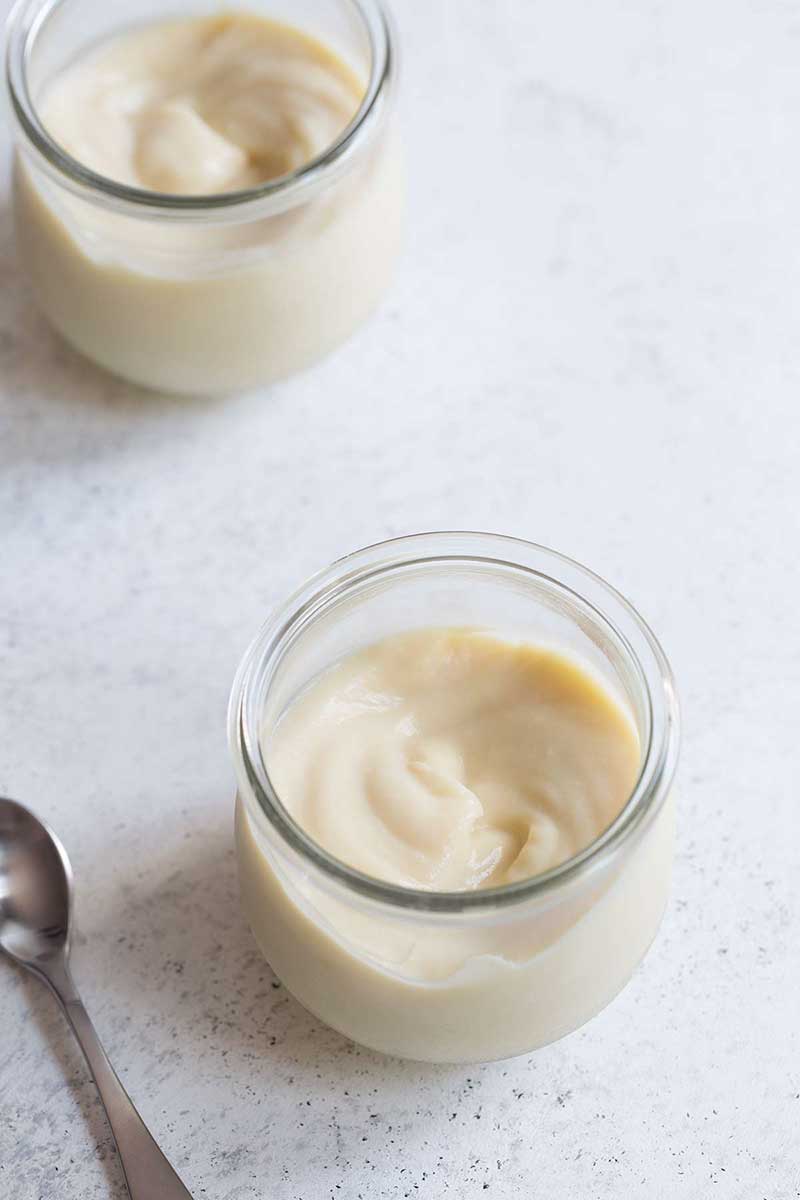 Closeup photo of easy vanilla pudding recipe on a pale backdrop