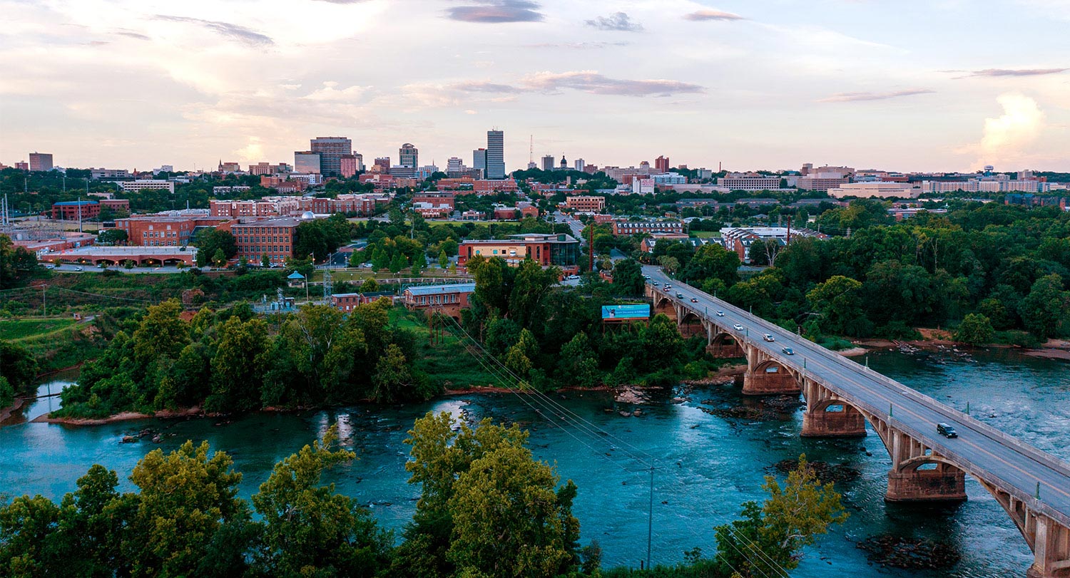 Drone photo of the Gervais Street bridge over the Congaree river going into Columbia with the skyline in the background.