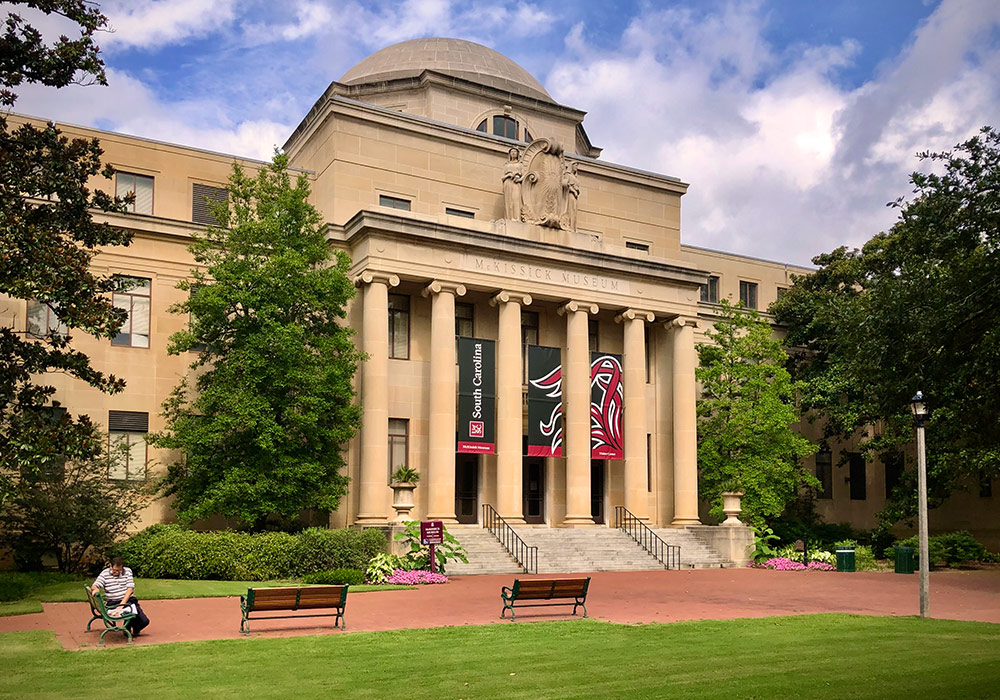 McKissick Museum sits at the top of the historic Horseshoe with large garnet banners featuring tailfeathers. 