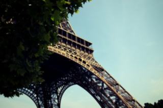 Two Women Taking a Picture in Front of the Eiffel Tower