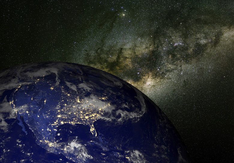 Earth from space at night and the Milky Way.