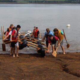 Scouts pulling raft out of water