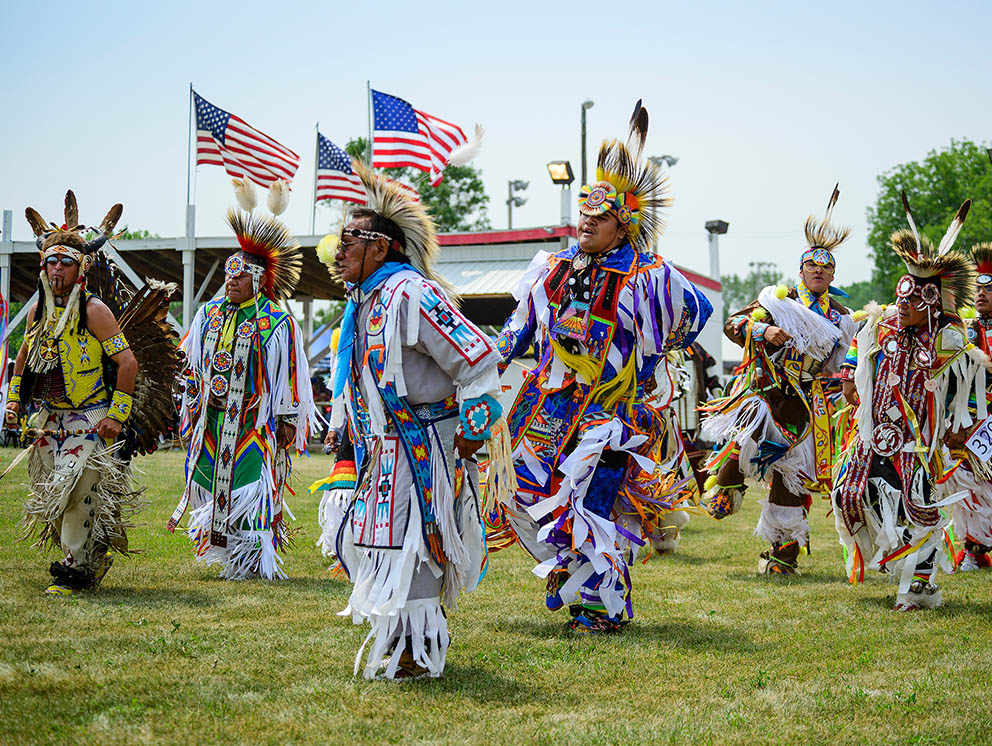 Indigenous people dancing at local ceremony.