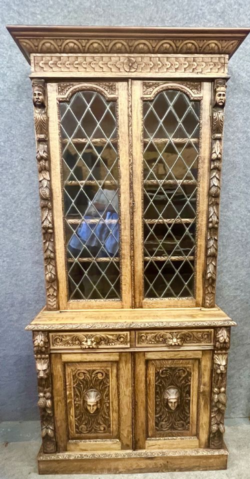 AN IMPRESSIVE 19THC CARVED OAK BOOKCASE