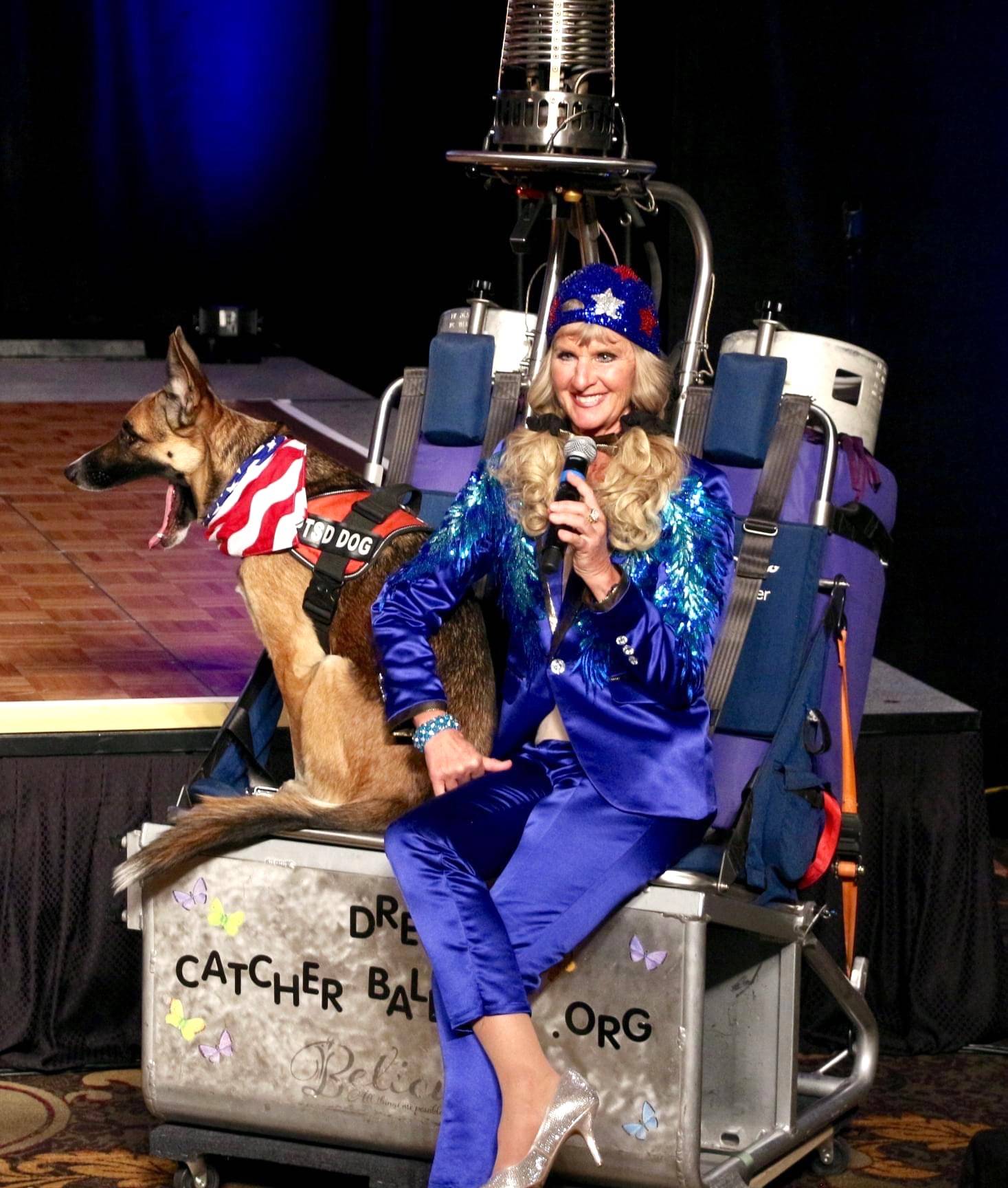 Captain-Crystal Stout, with her therapy dog Lucee Light, speaks to judges and audience members about her Dream Catcher Balloon Program on Oct. 8 during the Ms. Senior United States pageant. She received the title that night. Photo courtesy of Captain-Crystal Stout