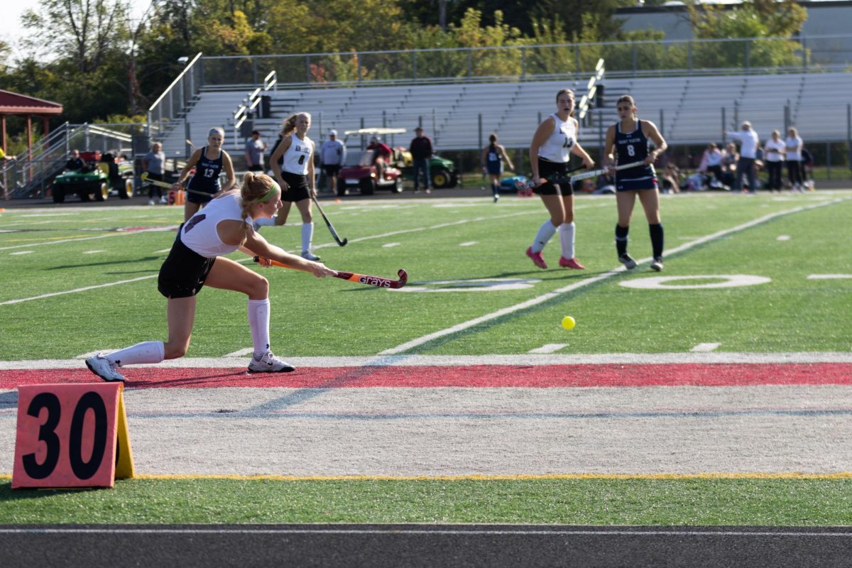 Senior Macie Volkmar inserting the ball against St. Viator.