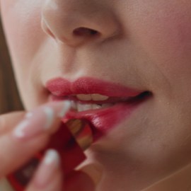 woman using tinted lip balm