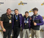 Tottenville Wrestling head coach John Cichon (far left) poses with his wrestlers (left to right: Connor Justesen, Tristan Levin and Jayden Kiell) after their strong performance at the NYSPHSAA State Championships in Albany on the weekend of Feb. 28.