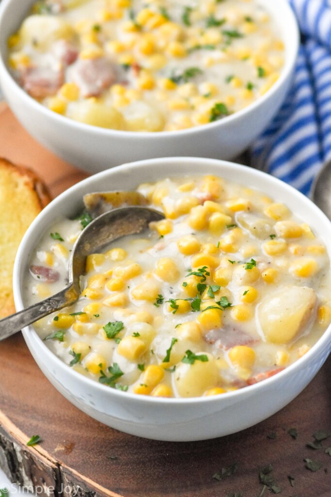 Bowls of Crockpot Corn Chowder with a spoon