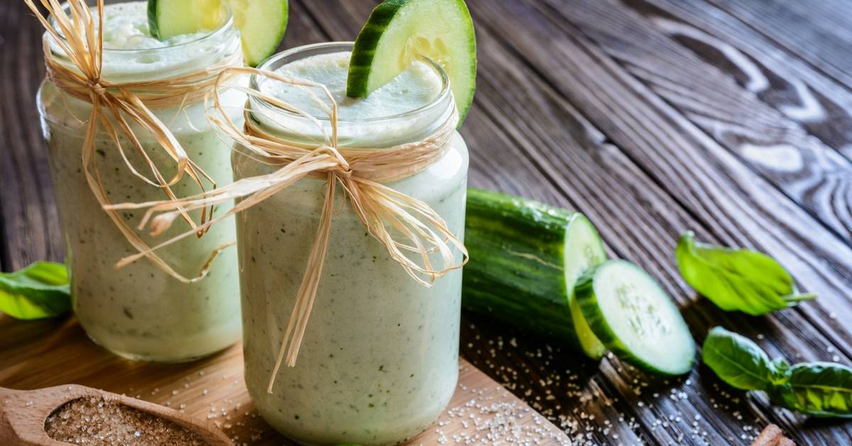 Bottles of Dr. Oz’s Green Smoothie and a spoon on the chopping board