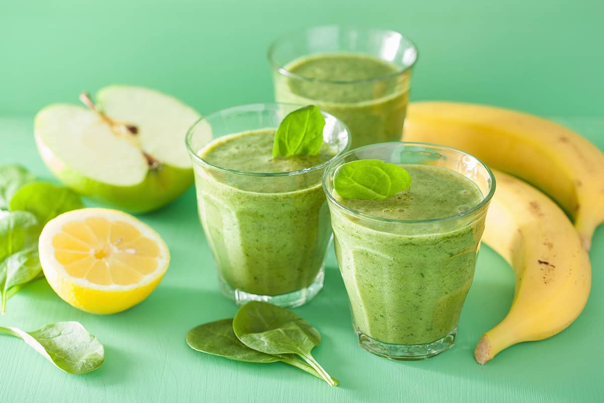 Cups of Spinach-Banana Smoothie and fruits