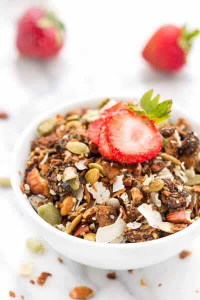 Coconut granola in bowl with strawberry on top