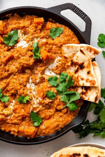 skillet of lentil curry with naan