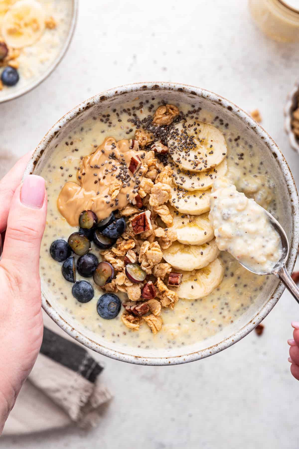 Overhead view of creamy protein oatmeal in bowl with toppings