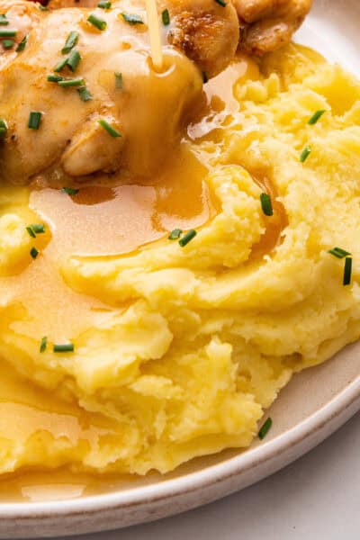 Closeup of dairy-free mashed potatoes on plate with gravy