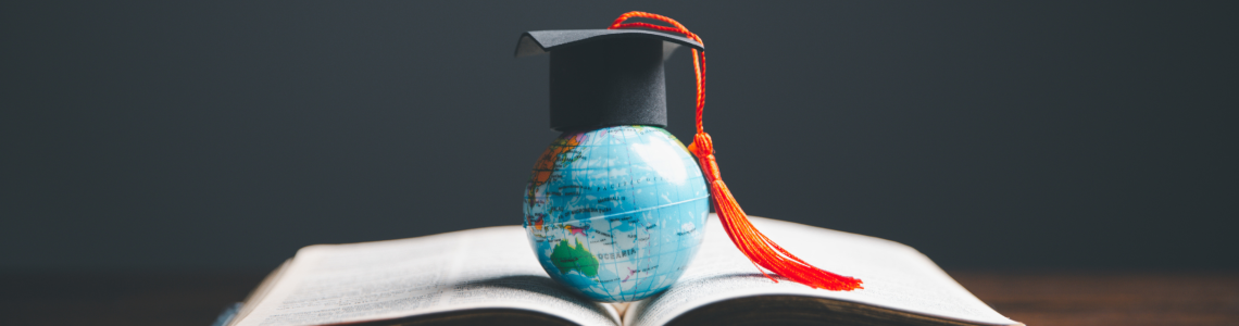 A globe with a graduation hat